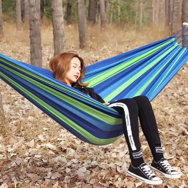 Portable hammock hanging between trees outdoors
